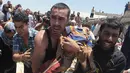 Warga menggendong seorang bocah yang tewas terkena serangan udara Israel di Gaza, Palestina, Rabu (9/7/14). (REUTERS/Ashraf Amrah)