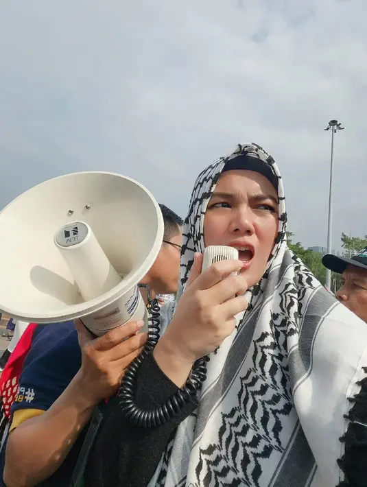 Bebi Silvana istri Opick tampak hadir di tengah-tengah partisipan massa aksi. Ia menggunakan pengeras suara untuk menyuarakan aksinya. [Instagram/bebi.silvana]
