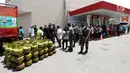 Suasana penjualan tabung gas elpiji 3 subsidi saat operasi pasar elpiji di SPBU Ki Hajar Dewantara di Palu, Sulawesi Tengah, Senin (8/10). Pertamina melakukan operasi pasar yang dijaga aparat polisi dan TNI. (Liputan6.com/Fery Pradolo)