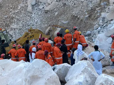 Petugas penyelamat melakukan pencarian korban di lokasi tambang marmer yang longsor di Mohmand, Pakistan, dekat perbatasan Afghanistan, Selasa (8/9/2020).  Sedikitnya 18 penambang tewas dan lebih dari selusin masih terjebak longsor yang terjadi pada Senin (7/9) malam. (AP Photo/Zubair Khan)