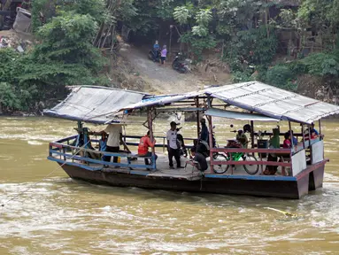 Warga menaiki perahu eretan di Sungai Cisadane, Neglasari, Kota Tangerang, Kamis (7/10/2021). Warga di kawasan tersebut masih memanfaatkan jasa penyeberangan perahu eretan untuk menyebrangi Sungai Cisadane. (Liputan6.com/Angga Yuniar)
