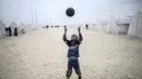 Bocah Syria bermain sepak bola di kamp pengungsian di Suruc, Propinsi Sanliurfa. (AFP PHOTO / BULENT KILIC)