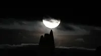 Bulan purnama yang dikenal sebagai Harvest moon muncul di atas Whitby Abbey, di Whitby, Inggris, Senin (20/9/2021). Ahli bulan NASA, Gordon Johnston, menerangkan harvest moon adalah bulan purnama yang paling dekat dengan titik balik musim gugur. (AP Photo/Alastair Grant)