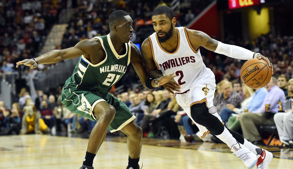 Pemain Cleveland Cavaliers, Kyrie Irving (kanan) menggiring bola melewati hadangan pemain Milwaukee Bucks, Tony Snell (kiri) pada laga NBA di Quicken Loans Arena, Cleveland, (21/12/2016). Cavaliers menang 113-102. (Reuters/Ken Blaze-USA TODAY Sports)