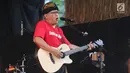 Penyanyi Iwan Fals membawakan lagu sambil bermain gitar dalam Seri Konser Situs Budaya di Panggung Kita, Depok, Sabtu (3/3). Dalam konser tersebut, Iwan Fals membawakan lagu-lagu daerah seperti Tegining Amaq dan Sarompi Mpida. (Liputan6.com/Arya Manggala)