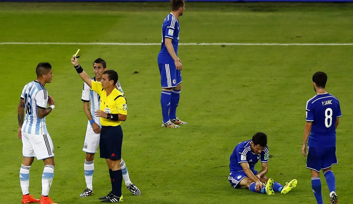 Pemain belakang Argentina, Marcos Rojo (kiri) harus menerima kartu kuning akibat melanggar Mensur Mujdza (kedua dari kanan) di laga penyisihan Piala Dunia 2014 Grup F di Estadio do Maracana, Rio de Janeiro, Brasil, (16/6/2014). (AFP PHOTO/Ricardo Moraes) 