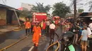 Sejumlah orang berkumpul melihat upaya pemadaman api yang membakar sebuah percetakan dan pabrik roti di Jalan Cawang Baru, Kavling Otista, Jakarta, Selasa (19/9). Kobakarn api tersebut telah menjalar di pemukiman padat penduduk (Liputan6.com/Angga Yuniar)