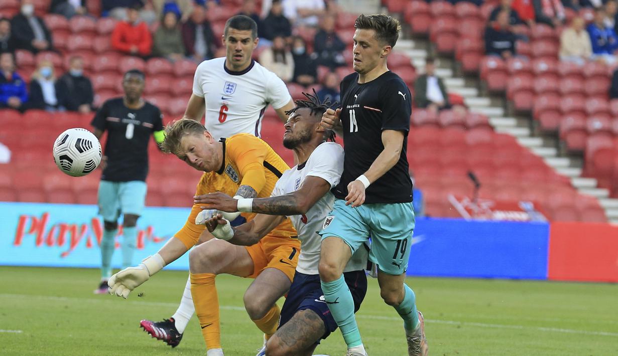 Bek Inggris, Tyrone Mings (kedua dari kanan) dan kiper Jordan Pickford berebut bola dengan gelandang Austria, Christoph Baumgartner dalam laga uji coba menjelang berlangsungnya Euro 2020 di Riverside Stadium, Middlesbrough, Rabu (2/6/2021). Inggris menang 1-0 atas Austria. (AP/Lindsey Parnaby/Pool)