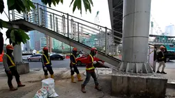 Pekerja melakukan Pembongkaran Jembatan Penyebrangan Orang (JPO) di Kawasan Bundaran HI, Jakarta, Senin (30/7). JPO yang sempat menimbulkan kontreversi itu dirobohkan karena alasan keindahan dan tak ramah penyandang disabilitas. (Liputan6.com/Johan Tallo)