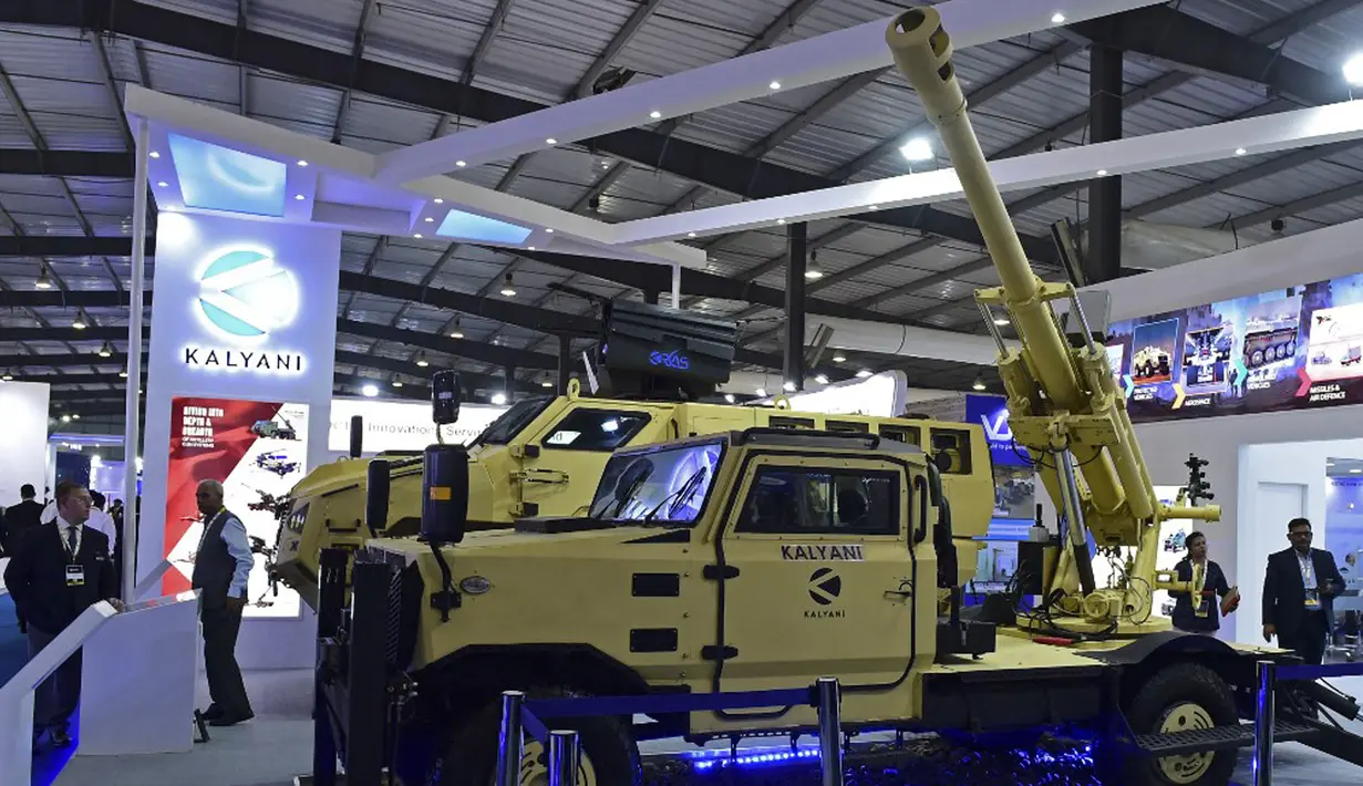 Pengunjung berdiri di samping sistem senjata Garuda 105 V2 yang dipasang pada kendaraan di Defence Expo 2022, Gandhinagar, India, 18 Oktober 2022. Defense Expo 2022 ini akan berlangsung selama lima hari. (Sam PANTHAKY/AFP)