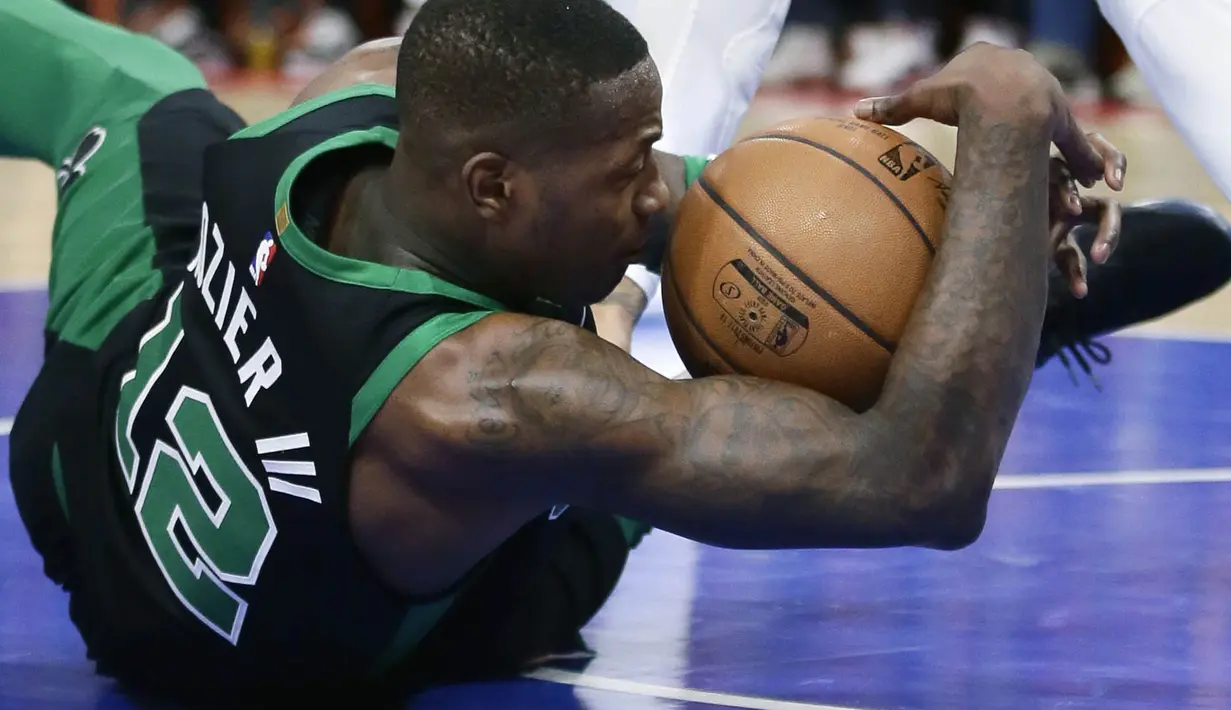 Pebasket Boston Celtics, Terry Rozier, terjatuh saat berebut bola dengan pebasket Detroit Pistons, Eric Moreland, pada laga NBA di Little Caesars Arena, Senin (11/12/2017). Celtics menang 91-81 atas Pistons. (AP/Duane Burleson)