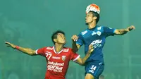 Arif Suyono (kanan) saat berduel dengan Agus Nova (Bali United). Arif Suyono membawa Arema menang 1-0 atas Bali United, Minggu (7/8/2016). (Bola.com/Iwan Setiawan)