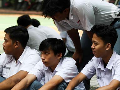 Sejumlah pelajar yang terjaring razia sebelum dipangkas rambutnya di SMA Negeri 70 Jakarta, Kamis (25/5/2023). (Liputan6.com/Herman Zakharia)