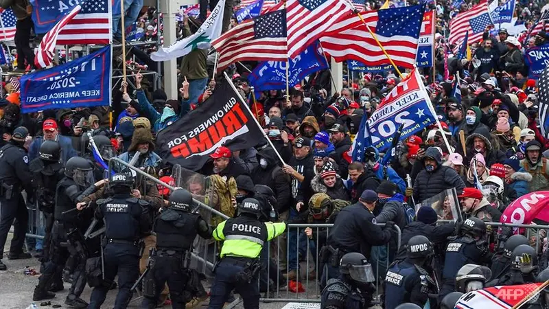 Pendukung Trump bentrok dengan polisi dan pasukan keamanan saat mereka menyerbu Capitol AS di Washington, DC pada 6 Januari 2021.