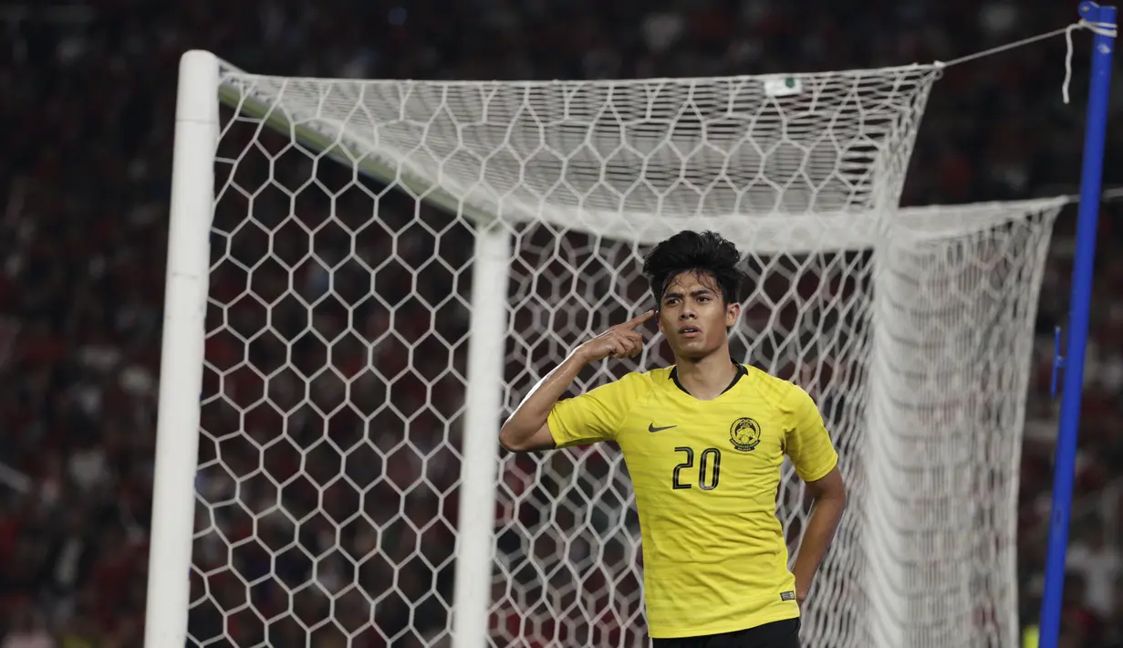 Striker Malaysia, Muhammad Syafiq, merayakan gol yang dicetaknya ke gawang Timnas Indonesia pada laga Kualifikasi Piala Dunia 2022 di SUGBK, Jakarta, Kamis (5/9). Indonesia kalah 2-3 dari Malaysia. (Bola.com/Vitalis Yogi Trisna)