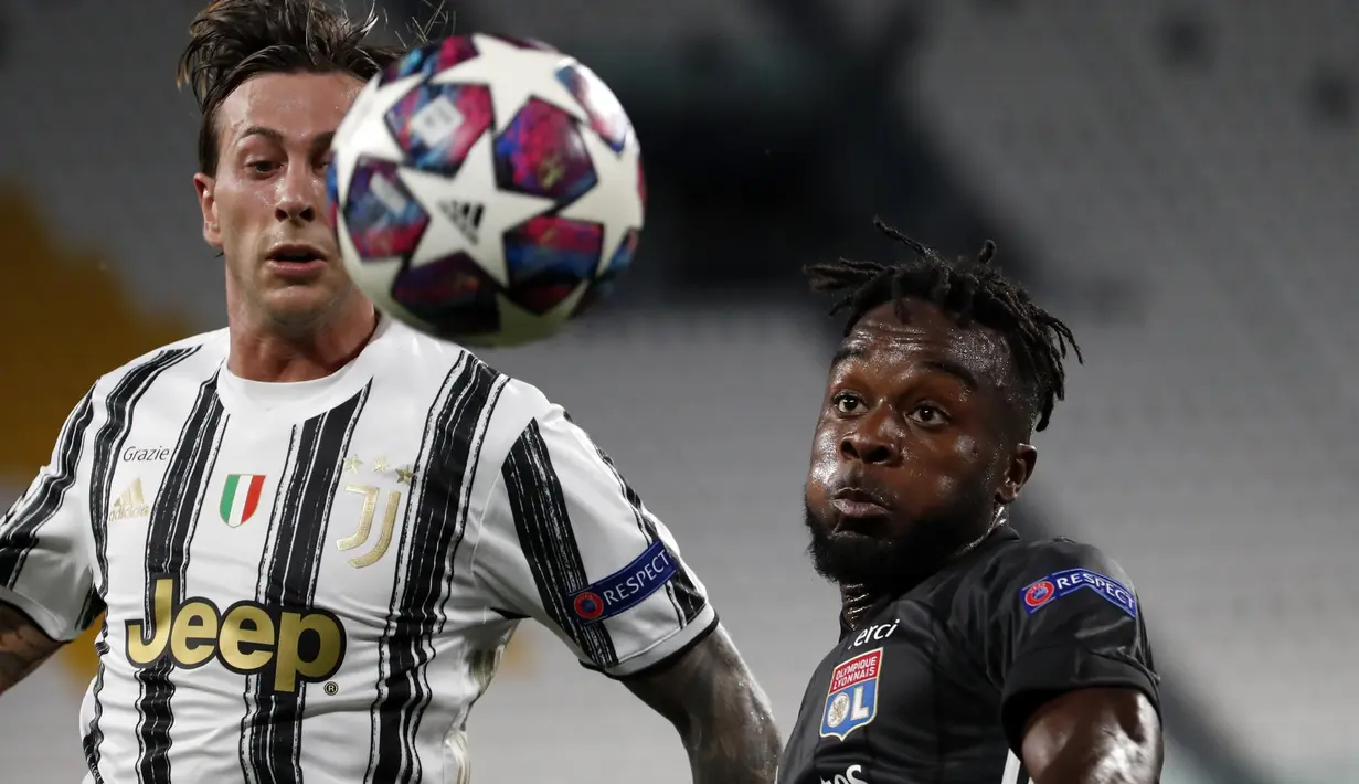 Gelandang Juventus, Federico Bernardeschi berebut bola dengan pemain Lyon, Kenny Tete pada leg kedua babak 16 besar Liga Champions di Allianz stadium, Turin, Italia (7/8/2020). Juventus menang 2-1 atas Lyon, namun tersingkir dari Liga Champions setelah aggregat skor 2-2. (AP Photo/Antonio Calanni)