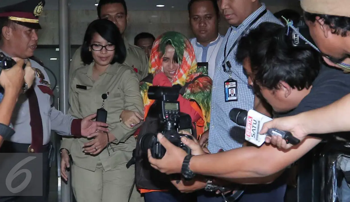 Pengusaha Rinelda Bandoso (tengah) meninggalkan gedung KPK usai menjalani pemeriksaan, Jakarta, Kamis (22/10) dini hari. Rinelda resmi ditahan terkait dugaan suap proyek pengembangan pembangkit listrik mikrohidro Papua. (Liputan6.com/Angga Yuniar)