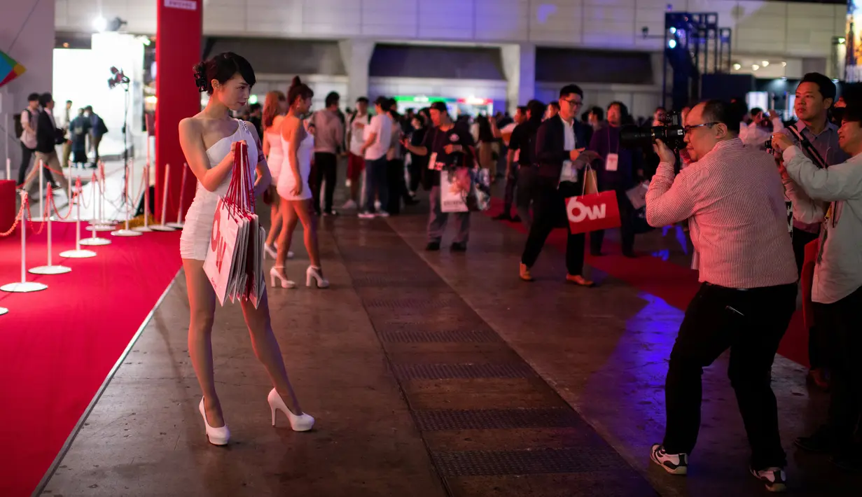 Seorang pria mengambil gambar model berkostum karakter video game saat gelaran Tokyo Game Show 2018 di Tokyo, Jepang, Jumat (21/9). Salah satu perhelatan gaming terbesar untuk kawasan Asia tersebut diadakan hingga 23 September nanti. (AFP / Martin BUREAU)