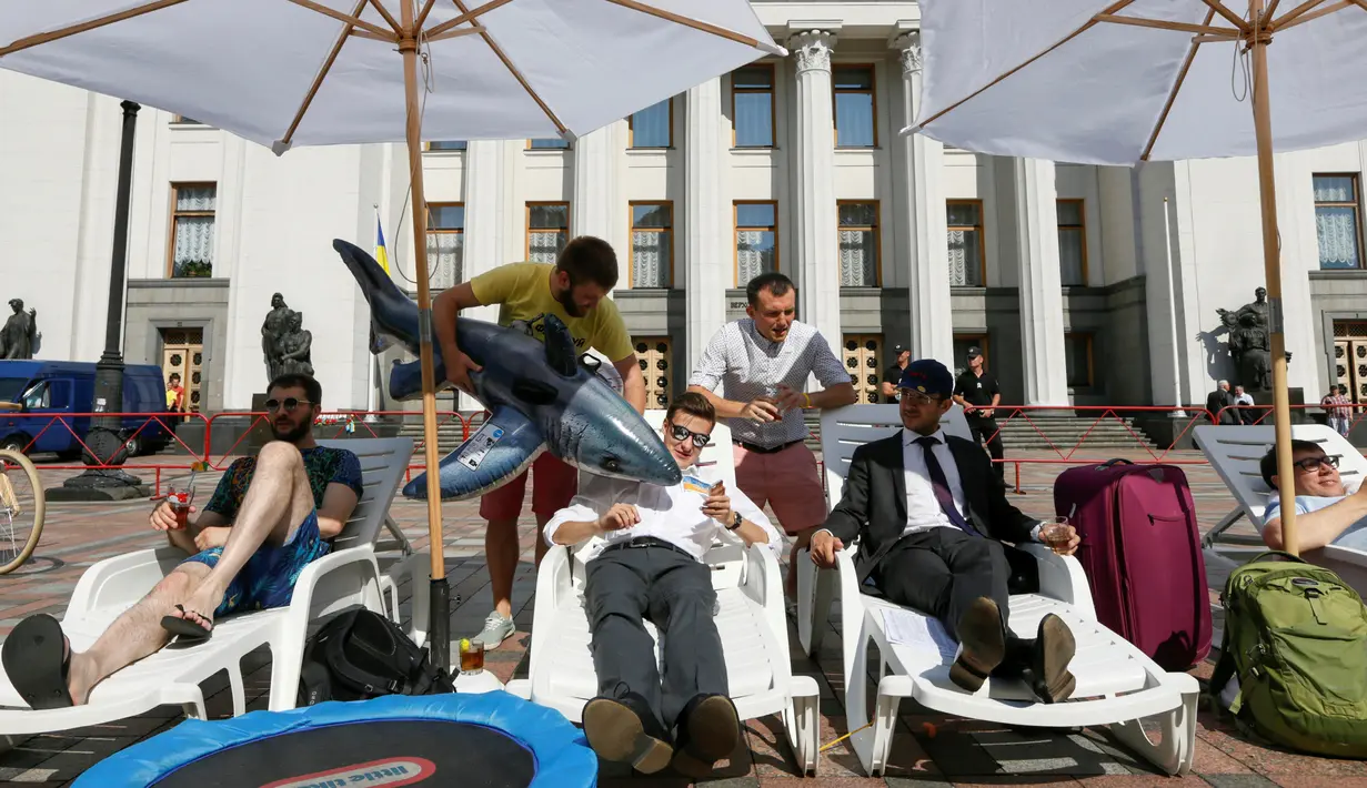 Sejumlah aktivis melakukan aksi di depan gedung parlemen Kiev, Ukraina, (12/7). Mereka menuntut para anggota parlemen untuk bekerja dan menyelesaikan tugas mereka dengan baik bukannya mengundur waktu. (REUTERS / Valentyn Ogirenko)