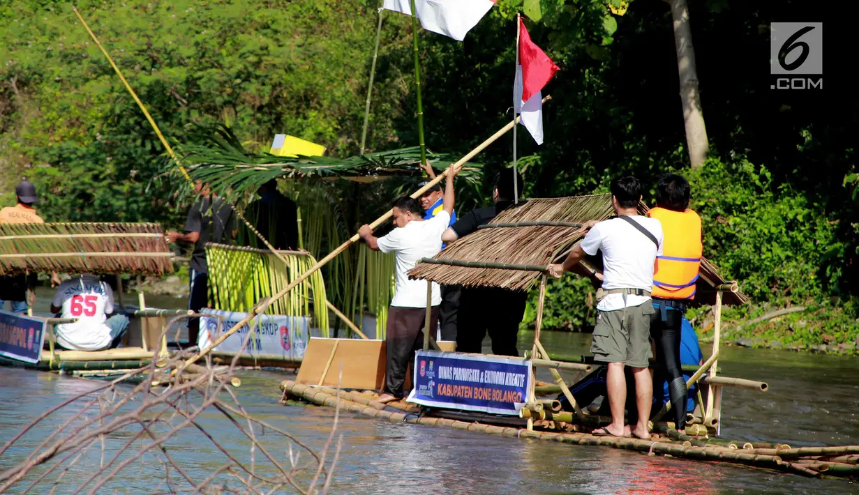 Peserta menyusuri sungai Bone menggunakan rakit tradisional di Gorontalo, Sabtu (23/3). Kegiatan ini dilaksanakan sebagai upaya meningkatkan kesadaran masyarakat Bonebol untuk bisa menjaga kelestarian sungai. (Liputan6.com/Arfandi Ibrahim)