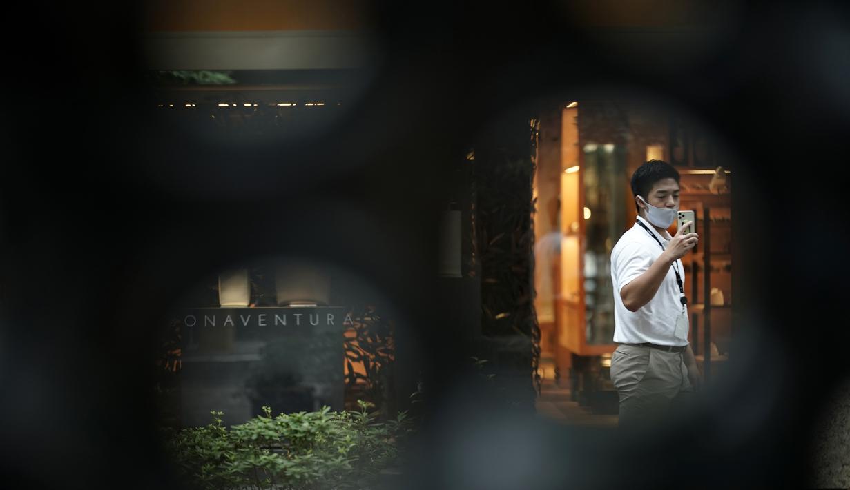 Seorang pria yang mengenakan masker untuk membantu mencegah penyebaran virus corona berjalan melalui pusat kota Tokyo, Kamis (10/9/2020). Ibu kota Jepang itu mengonfirmasi lebih dari 270 kasus virus corona pada Kamis. (AP Photo / Eugene Hoshiko)