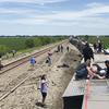 Sebuah kereta penumpang Amtrak tergeletak di sisinya setelah tergelincir di dekat Mendon, Missouri, Amerika Serikat (27/6/2022). Dilaporkan hampir 243 penumpang terluka akibat insiden tersebut. (Dax McDonald via AP)
