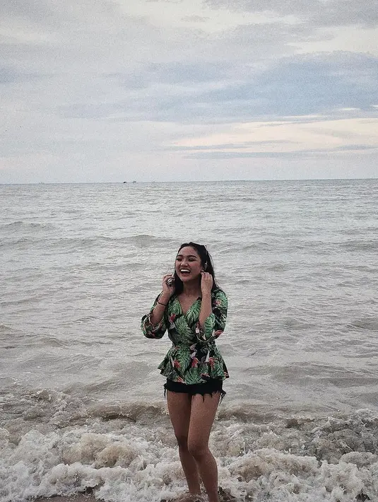 Sepertinya pantai menjadi tempat favorite Marion Jola untuk liburan, dan kali ini ia memakai hot pants hitam dengan atasan hijau. Cantik banget ya? (Instagram/lalamarionmj)