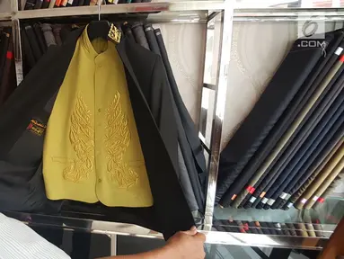 Pekerja menunjukkan pakaian yang akan dikenakan para Raja Adat saat ngunduh mantu Kahiyang-Bobby di Medan, Kamis (23/11). Untuk acara adat tersebut, pihak keluarga telah mempersiapkan busana khusus untuk para Raja. (Liputan6.com/Aditya Eka)