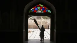 Seorang relawan membersihkan gerbang utama sebuah masjid jelang datangnya bulan puasa Ramadhan, di Peshawar, Pakistan, Sabtu (2/4/2022). Bulan Ramadhan atau sering kita sebut bulan puasa adalah bulan yang di tunggu-tunggu oleh umat Islam di seluruh dunia. (AP Photo/Muhammad Sajjad)
