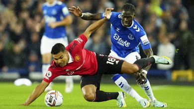 Gelandang Manchester United, Casemiro berebut bola dengan pemain Everton, Amadou Onana pada pertandingan lanjutan Liga Inggris di Goodison Park, di Liverpool, Inggris, Senin (10/10/2022). Sementara itu, Everton harus puas menelan kekalahan ketiganya dari delapan pertandingan. (AP Photo/Jon Super)