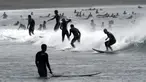 Orang-orang berselancar di pantai Katase-kaigan yang berangin, Fujisawa, Prefektur Kanagawa, selatan Tokyo, Jepang, Kamis (24/9/2020). Badai Tropis Dolphin bergerak di sepanjang pantai Pasifik Jepang. (AP Photo/Eugene Hoshiko)
