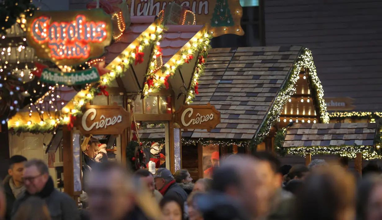 Orang-orang mengunjungi pasar Natal tradisonal pada hari pembukaannya di Frankfurt am Main, Jerman, Senin (25/11/2019). Sesuai dengan namanya, tempat ini adalah sebuah pasar yang bertemakan Natal. (Photo by Daniel ROLAND / AFP)