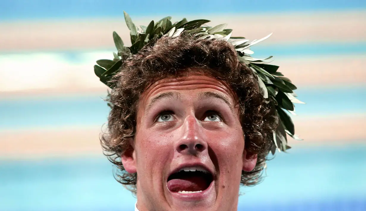 Pada Olimpiade pertamanya di Athena 2004, Ryan Lochte langsung berhasil mempersembahkan medali emas. Lochte yang saat itu masih 20 tahun memenangi nomor beregu 4x200 m gaya bebas. (AFP/Francois Xavier) 