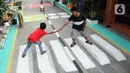 Anak-anak bermain di atas lukisan tiga dimensi (3D) di Jalan Perumahan Bojong Depok Baru 1, RT 03/RW 19 Bojonggede, Bogor, Jawa Barat, Selasa (3/8/2020). Dalam rangka menyambut HUT ke-75 RI, warga berbenah memperindah lingkungan dengan melukis 3D pada jalan. (merdeka.com/Arie Basuki)