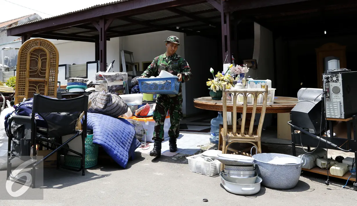 Prajurit TNI mengangkat barang dari dalam rumah di kawasan komplek Detasemen Intel (Denintel) Kodam Jayakarta, Cibubur, Jakarta, Kamis (3/9/2015). Sebanyak 99 rumah dikosongkan oleh Kodam Jaya. (Liputan6.com/Yoppy Renato)