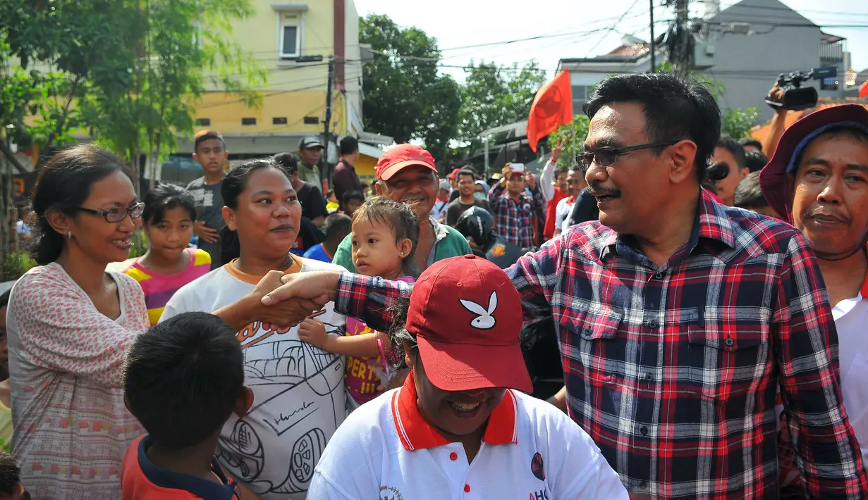 Cagub DKI Jakarta Djarot Saiful Hidayat berjabat tangan dengan warga saat melakukan blusukan di Kebon Bawang, Jakarta Utara, Sabtu (26/11). Dalam blusukannya tersebut, Djarot menjelaskan mengenai program KJP. (Liputan6.com/Angga Yuniar)