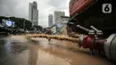 Mesin menyemprotkan air saat terjadi genangan akibat kebocoran saluran pipa air di kawasan Bundaran Hotel Indonesia (HI), Jakarta, Selasa (11/10/2022). Kebocoran pipa air diduga terimbas proyek revitalisasi Halte Bundaran Hotel Indonesia. (Liputan6.com/Faizal Fanani)