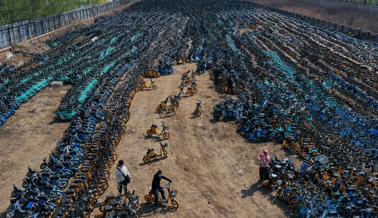 Foto udara pada 19 April 2021 ini menunjukkan tumpukkan sepeda publik yang ditinggalkan di Shenyang, timur laut China. Ribuan sepeda yang awalnya disewakan secara online tersebut, dibiarkan terbengkalai karena banyak operator penyewaan sepeda yang bangkrut akibat pandemi Covid-19. (STR/AFP)