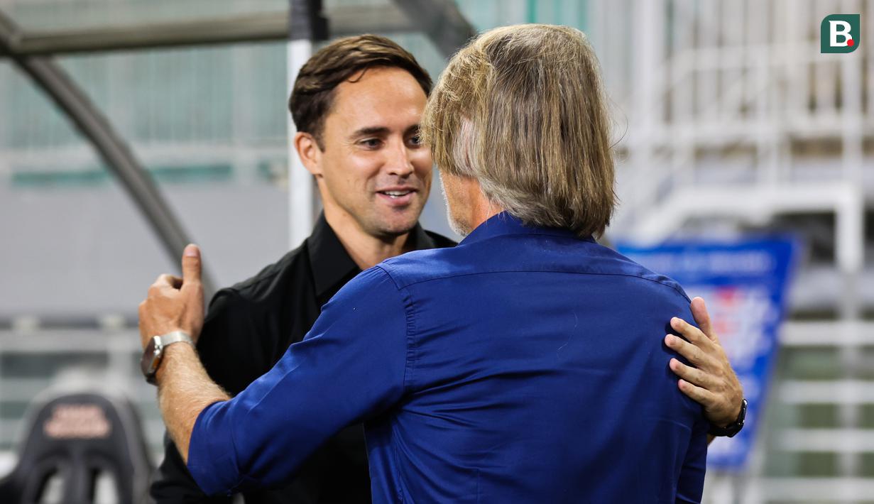 Pelatih Persebaya Surabaya, Paul Munster menyapa pelatih Dewwa United, Jan Olde Riekerink sebelum kedua tim bertanding pada pekan ke-24 BRI Liga 1 di Stadion Pakansari, Kabupaten Bogor, Jumat (21/2/2025) malam WIB. (Bola.com/Abdul Aziz)