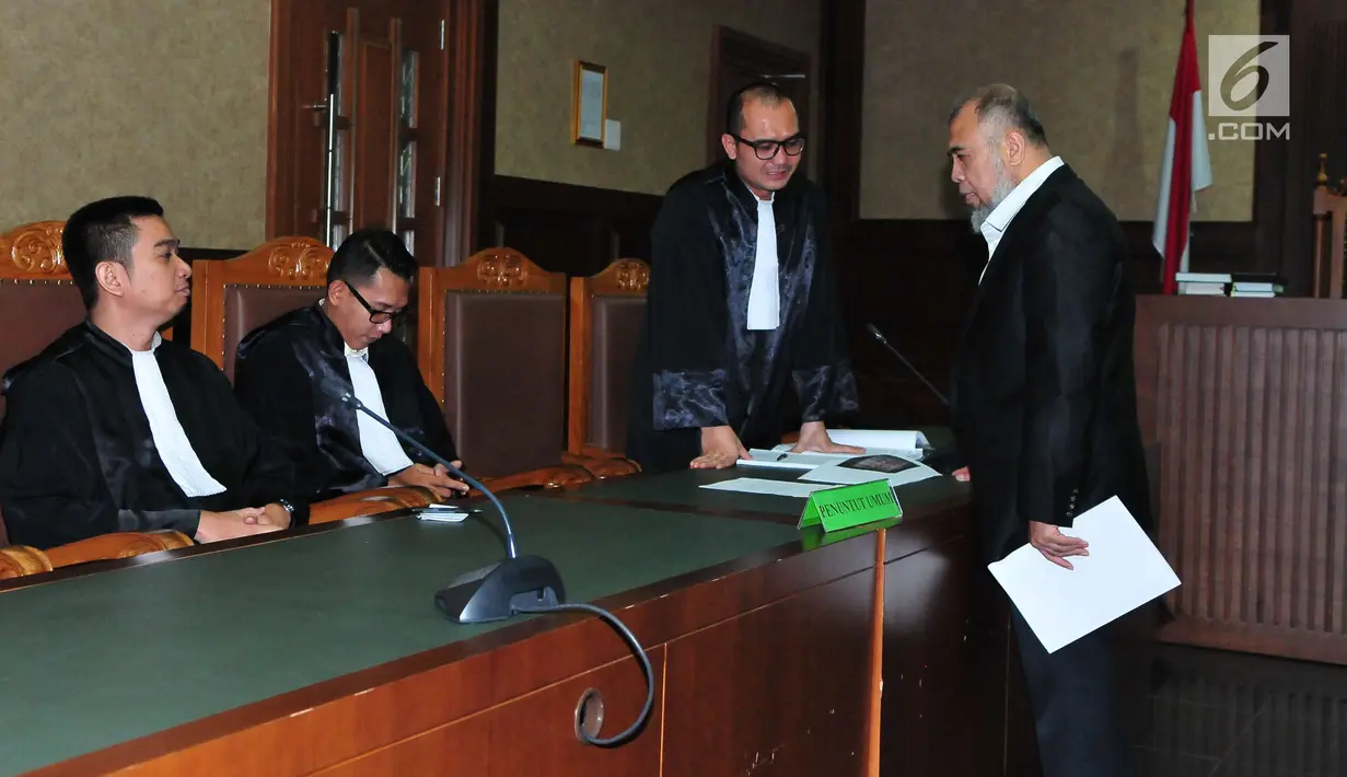Patrialis Akbar menunjukan Nota Pembelaan Pribadi kepada tim Penuntut Umum saat sidang di Gedung Pengadilan Tipikor, Jakarta, Senin (21/8). Patrialis keberatan dan menolak membayar uang pengganti dan denda. (Liputan6.com/Helmi Afandi)
