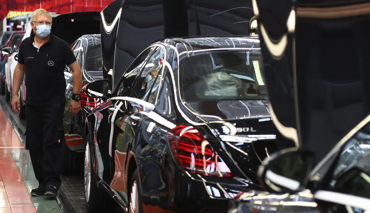Pekerja merakit mobil Mercedes-Benz S-class di pabrik Mercedes, Sindelfingen, Jerman, Kamis (30/4/2020). Mulai 27 April 2020, Mercedes-Benz kembali membuka jalur produksi yang sebelumnya ditutup karena pandemi virus corona COVID-19. (AP Photo/Matthias Schrader)
