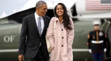 Presiden AS, Barrack Obama berjalan bersama putrinya, Malia, saat akan menaiki pesawat Air Force One dari Bandara O'Hare, Chicago, Kamis (7/4/2016). (REUTERS/Kevin Lamarque)