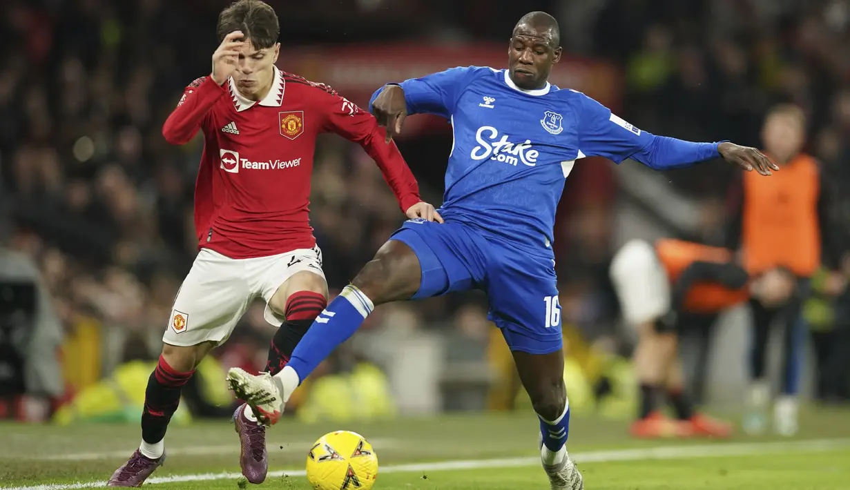 <p>Gelandang Manchester United, Alejandro Garnacho berusaha melewati pemain Everton, Abdoulaye Doucoure pada laga putaran ketiga Piala FA di Old Trafford di Manchester, Inggris, Sabtu (7/1/2023). Manchester United menang atas Everton dengan skor 3-1. (AP Photo/Dave Thompson)</p>