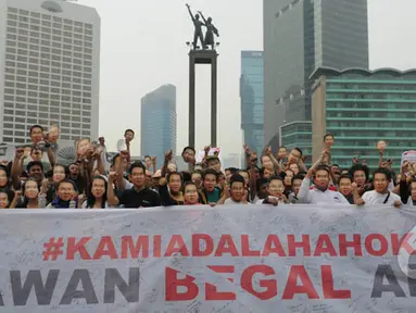 Ratusan orang yang menamakan dirinya sebagai "Teman Ahok." melakukan aksi di Bundaran HI, Jakarta, Minggu (1/3/2015). Aksi mereka sebagai bentuk dukungan kepada Ahok yang ingin membongkar dana siluman di Pemprov DKI (Liputan6.com/Herman Zakharia)