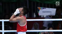 Petinju putra Indonesia, Sunan Agung Amoragam usai melawan Mirazizbek Mirzakhalilov (Uzbekistan) pada semifinal kelas bantam 56kg putra Asian Games 2018 di JIEXPO Kemayoran, Jumat (31/8). Sunan Agung Amoragam kalah 0-5. (Liputan6.com/Helmi Fithriansyah)