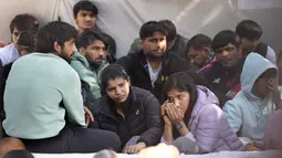 Sakshi Malik, pegulat India yang memenangkan medali perunggu di Olimpiade Musim Panas 2016, (kedua kiri) dan Bajrang Punia, yang memenangkan medali Perunggu di Olimpiade Tokyo 2020 (kiri) berpartisipasi dengan pegulat lain dalam protes terhadap Presiden Federasi Gulat India Brijbhushan Sharan Singh dan pejabat lainnya di New Delhi, India, Jumat (20/1/2023). Pegulat top India memimpin protes di dekat gedung parlemen menuduh presiden federasi dan pelatih melakukan pelecehan seksual dan mental terhadap pegulat muda. (AP Photo/Manish Swarup)