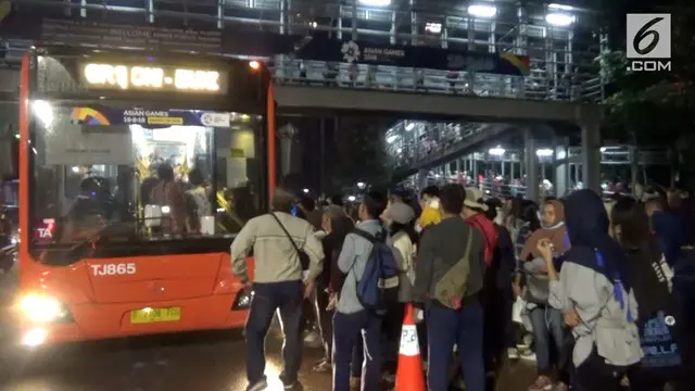 Antrian ribuan warga untuk naik bus Transjakarta gratis usai gelaran upacara penutupan Asian Games terjadi di sekitar Gelora Bung Karno, Minggu malam.