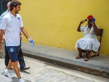 Raul Gonzales (kiri) pemain New York Cosmos berjalan di wilayah kota tua Havana, Kuba. (AFP/Yamil Lage)