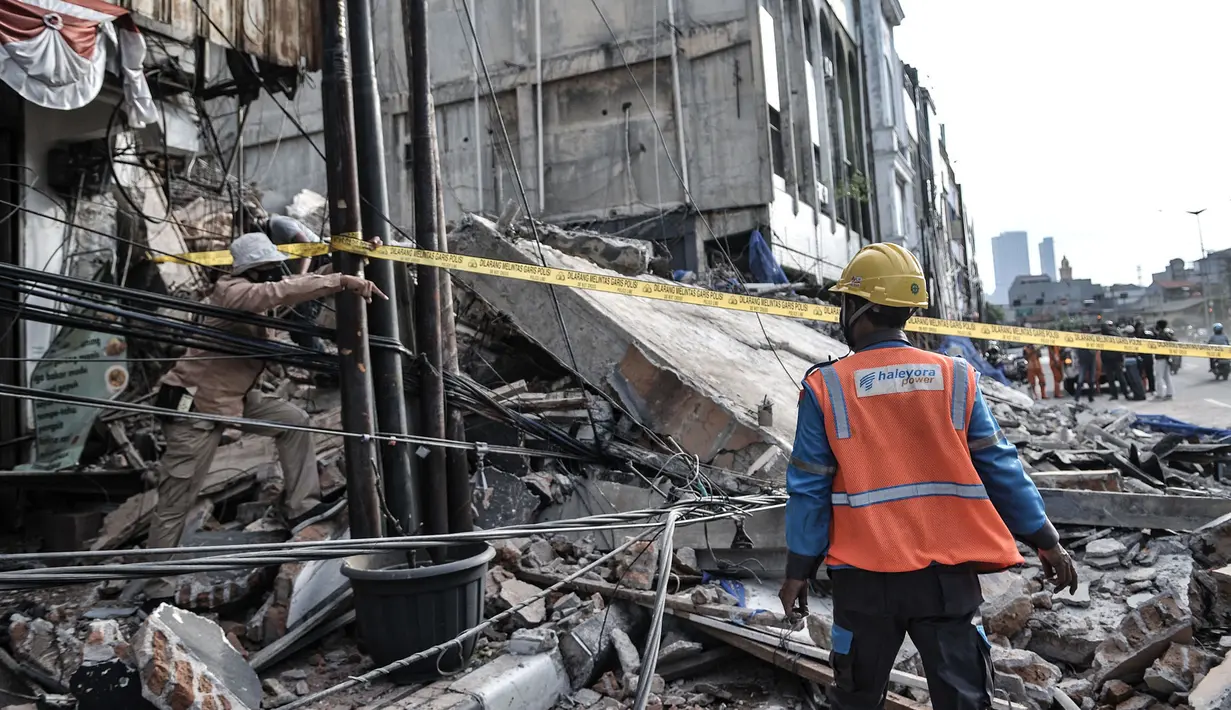 Garis polisi terpasang di sekitar lokasi bangunan roboh di Jalan Kyai Caringing, Gambir, Jakarta, Kamis (3/9/2020). Bangunan empat lantai itu roboh dan menimpa kabel listrik serta reruntuhannya menutupi jalan sehingga arus kendaraan arah Harmoni-Grogol sempat dialihkan. (merdeka.com/Iqbal Nugroho)