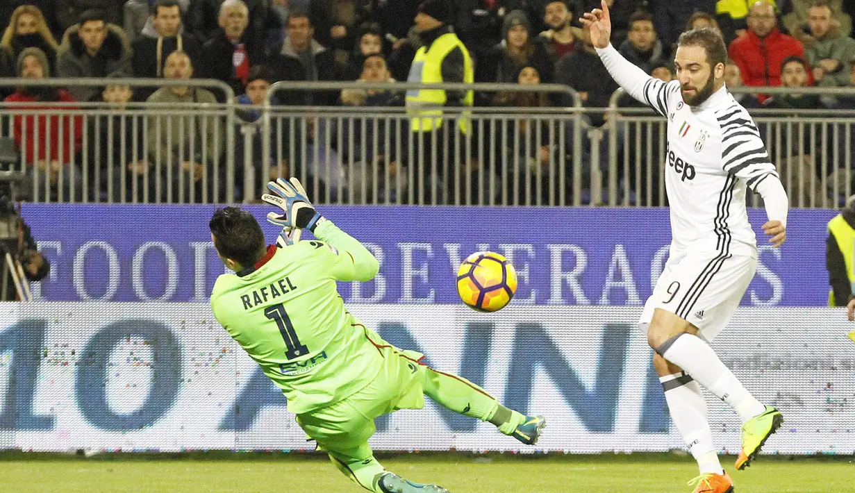 Penyerang Juventus, Gonzalo Higuain (kanan) mengecoh kiper Cagliari saat mencetak gol pada lanjutan Serie A di Sant'Elia Stadium, Cagliari (12/2/2017). (EPA/Fabio Murru)